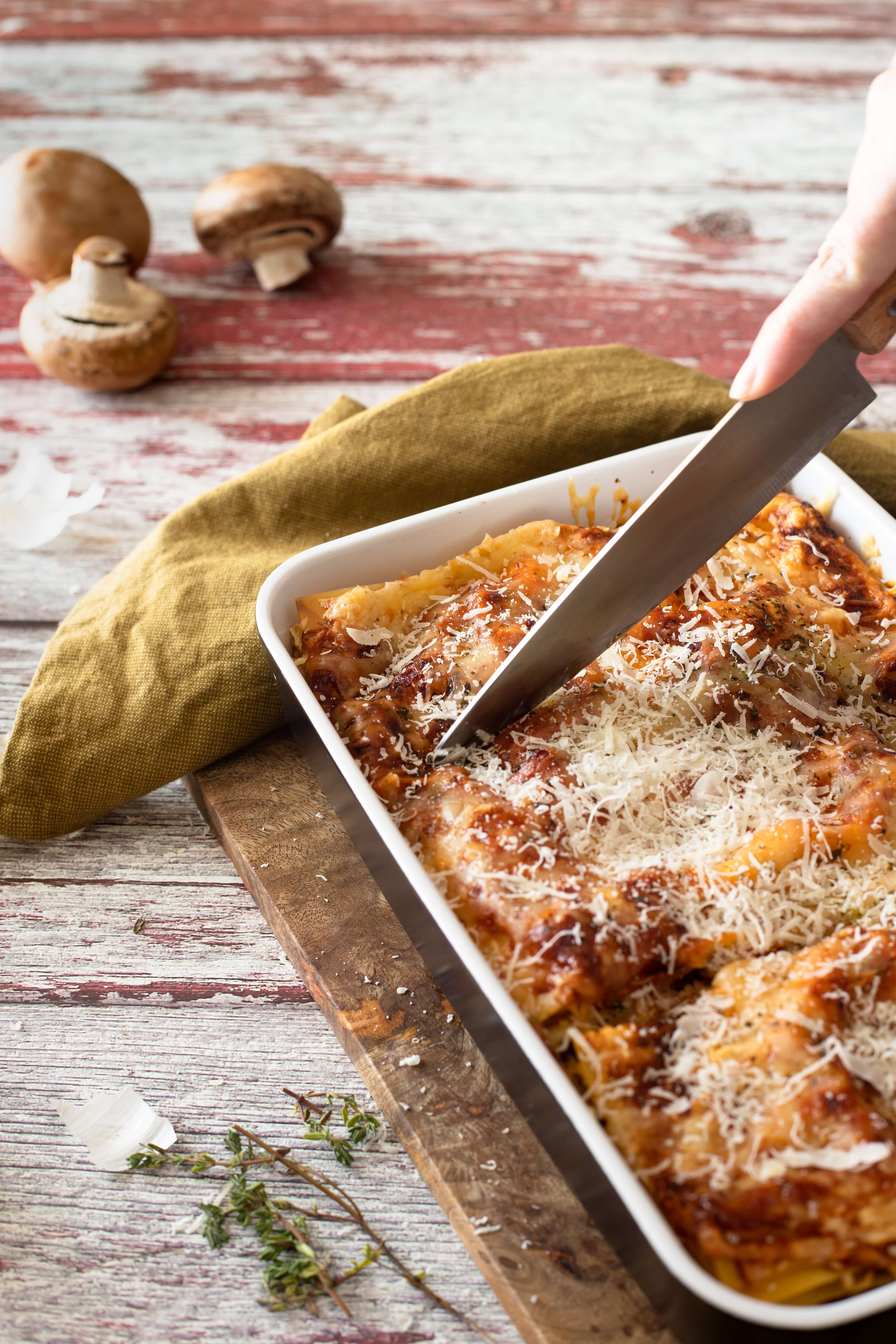 Image of knife cutting a Lasagna